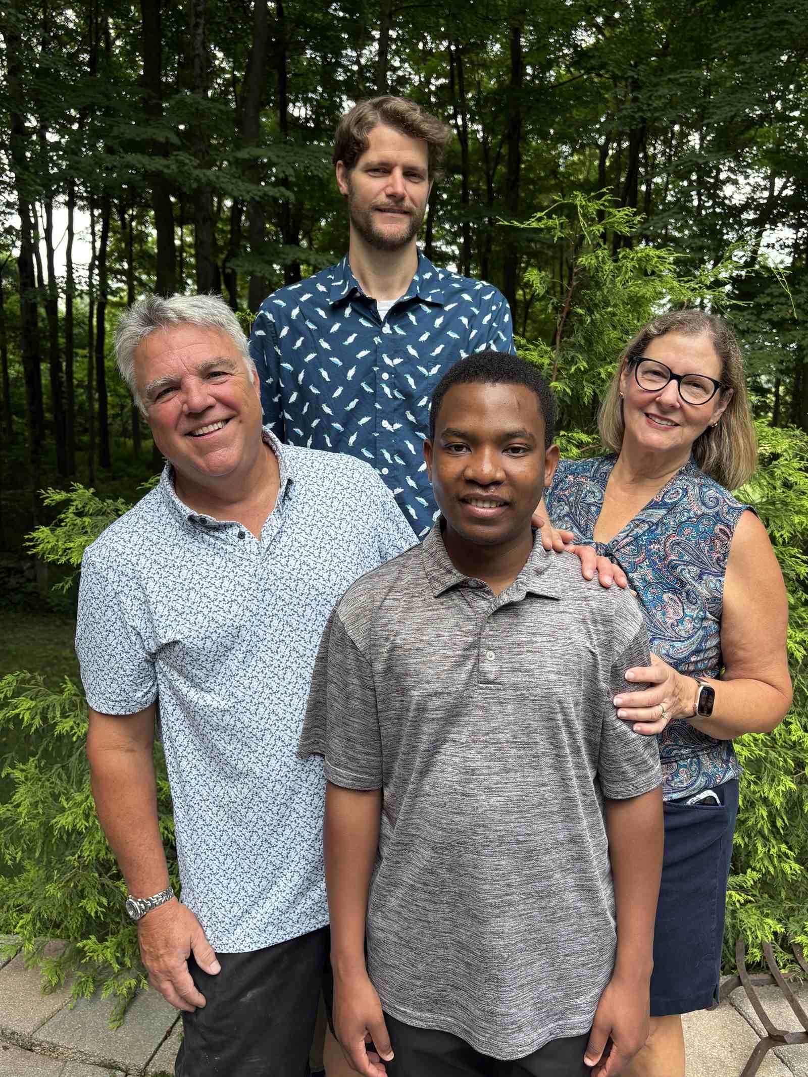 The UCHI board and Fr. Adrian standing together outdoors: Jim Ryan, Jim Jackson, Fr. Adrian and Sharon Tranovich.